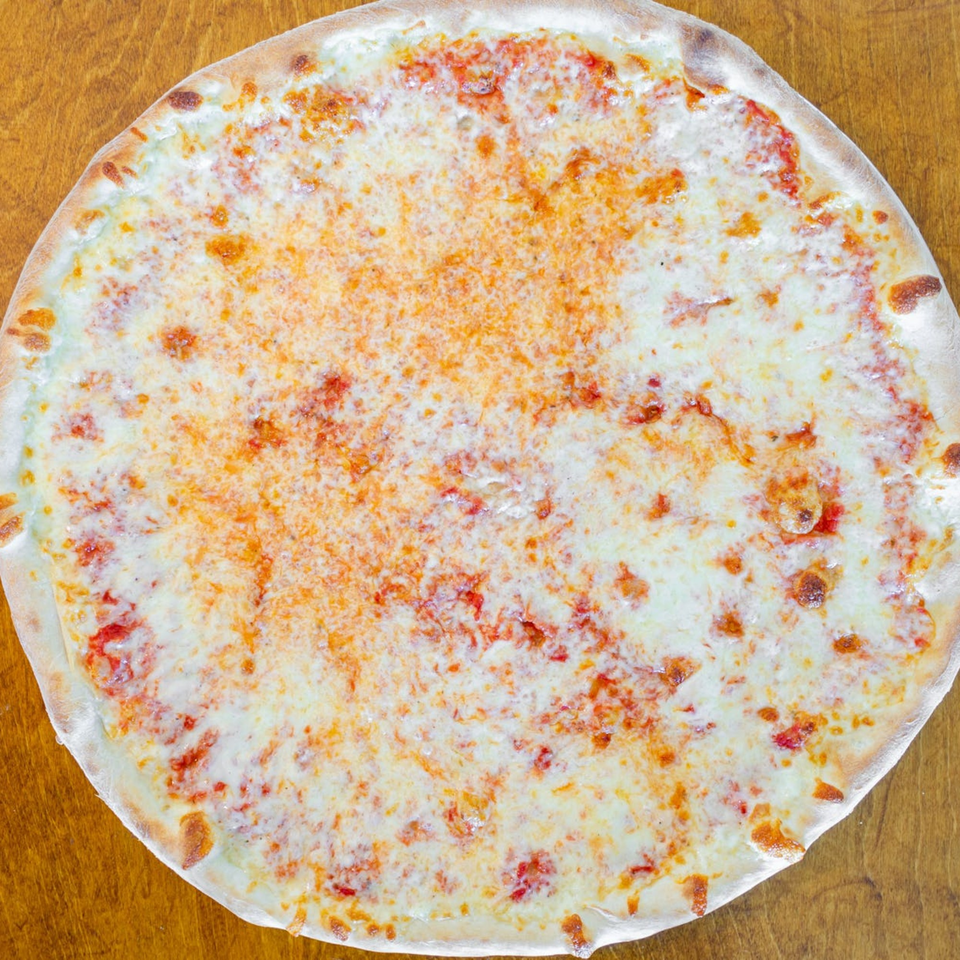 A whole, round Catania's Pizza cheese pizza with a golden crust on a wooden surface.